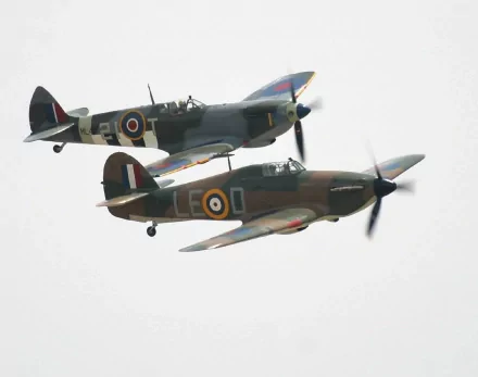 Two military aircraft fly in formation against a cloudy sky, showcasing their distinctive markings. This HD image serves as an impressive desktop wallpaper.