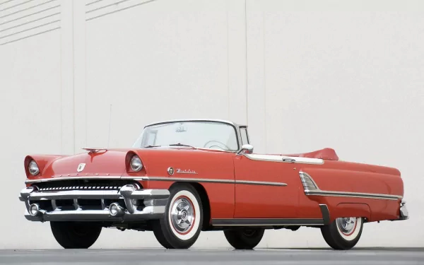 HD PC desktop wallpaper and background: red Mercury Montclair convertible with 1950s chrome trim and whitewall tires against a pale wall.