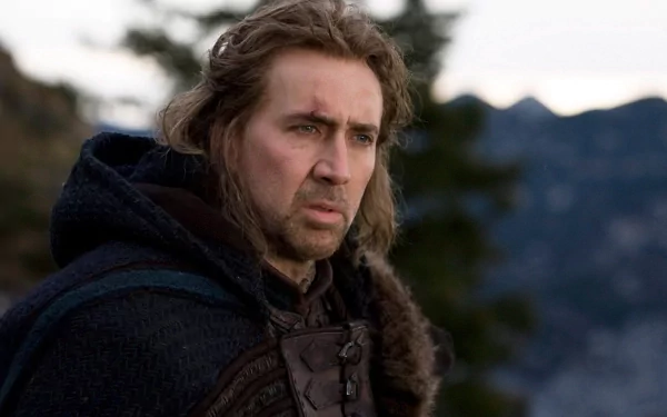 Nicolas Cage appears in a dramatic scene, showcasing a contemplative expression. This HD wallpaper captures his intensity against a mountainous backdrop.