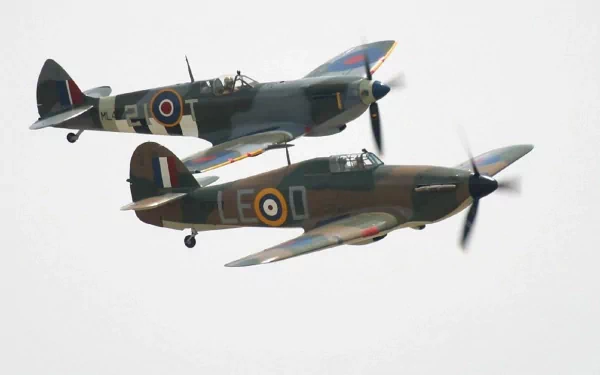 Two military aircraft fly in formation against a cloudy sky, showcasing their distinctive markings. This HD image serves as an impressive desktop wallpaper.