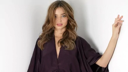 HD desktop wallpaper featuring celebrity Miranda Kerr posing confidently against a plain white background.