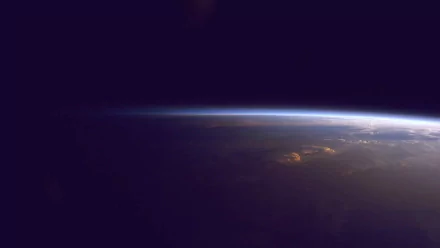HD wallpaper of Earth as viewed from space, showcasing the planet's curvature against the dark backdrop of space.