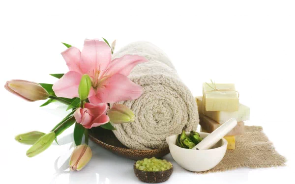 4K Ultra HD PC desktop wallpaper and background — man-made spa scene with rolled towel, pink lilies, soaps, mortar and pestle and green bath salts on white background.