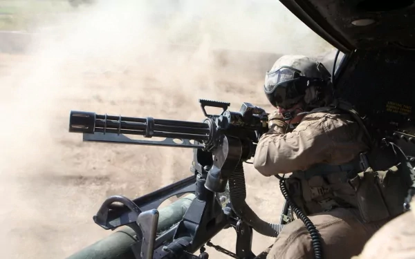 A soldier operating a machine gun from a military vehicle, surrounded by dust and smoke, captures the intensity of combat in this HD desktop wallpaper.