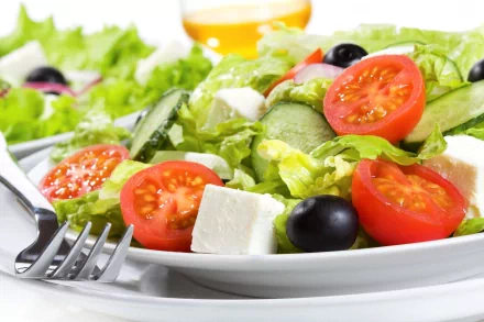 A vibrant salad featuring fresh greens, cherry tomatoes, cucumber, olives, and feta cheese, designed as a 4K Ultra HD PC desktop wallpaper and background.