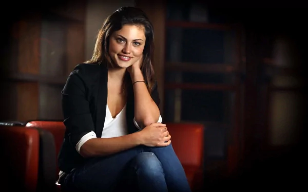 HD PC desktop wallpaper featuring celebrity Phoebe Tonkin seated, smiling gently against a softly blurred dark background.