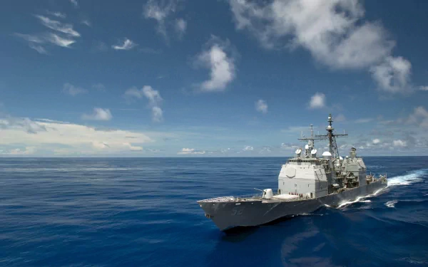 HD desktop wallpaper featuring the USS Barry (DDG-52), a military destroyer warship sailing under a partly cloudy sky.
