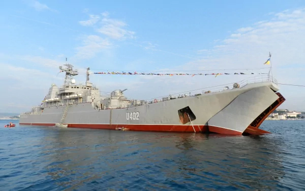 4K Ultra HD image of a military amphibious assault warship marked U402, floating on calm waters under a clear blue sky.