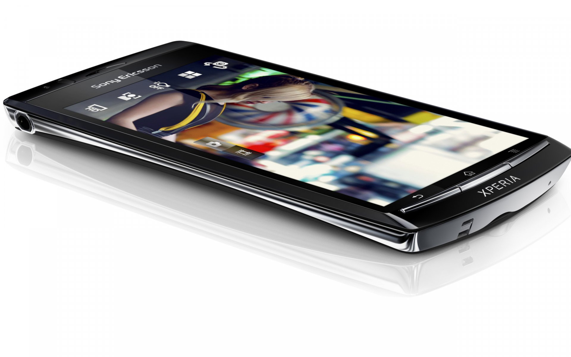 Sleek Sony Xperia smartphone angled on a white surface with colorful screen reflections — technology-themed 2K Quad HD PC desktop wallpaper and background.