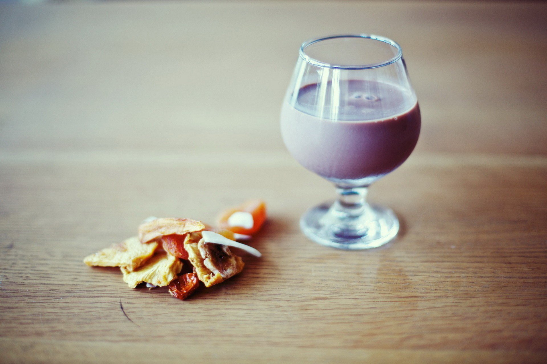 HD PC desktop wallpaper featuring a glass of chocolate drink alongside a small stack of assorted cookies on a wooden surface, highlighting food and drink themes.
