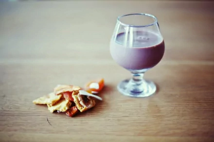HD PC desktop wallpaper featuring a glass of chocolate drink alongside a small stack of assorted cookies on a wooden surface, highlighting food and drink themes.