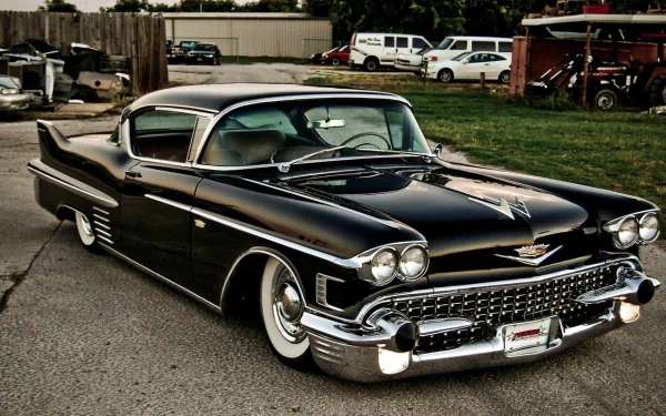 HD PC desktop wallpaper featuring a classic black Cadillac parked on a street with vintage detailing and polished chrome accents.