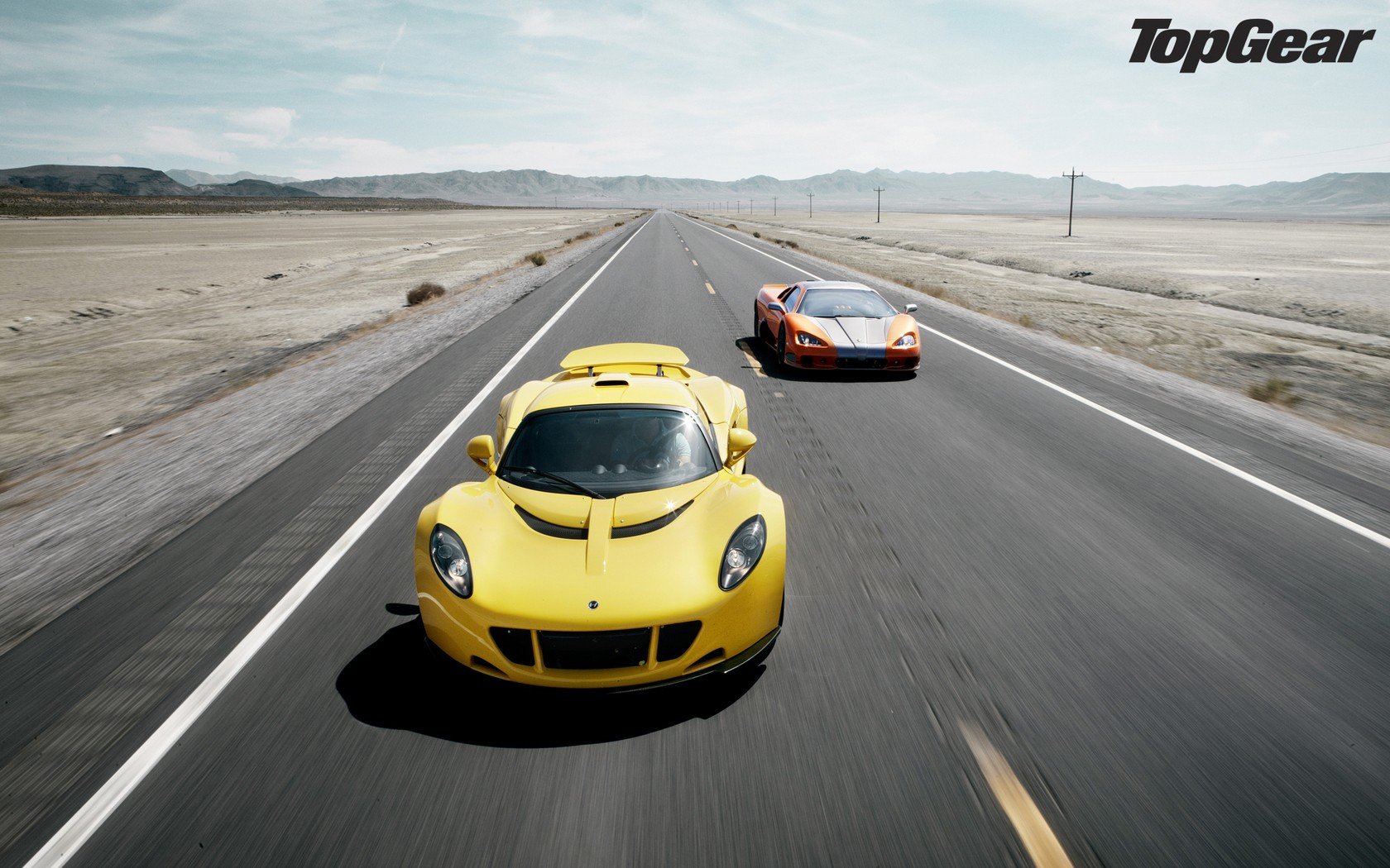 HD Top Gear desktop wallpaper featuring two high-performance cars racing on an open road.