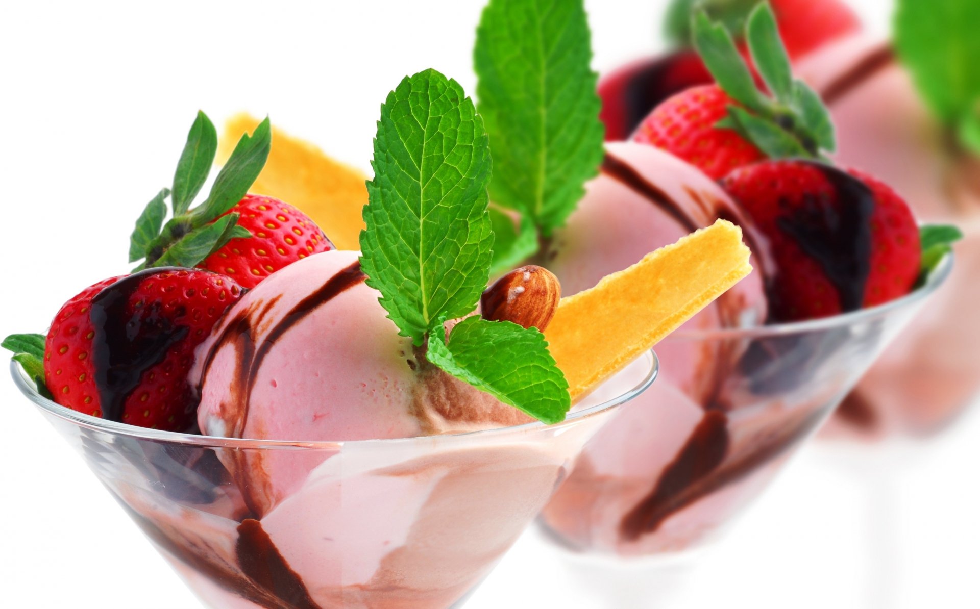 Delicious ice cream served in elegant glasses, topped with fresh strawberries, orange slices, and mint leaves. A vibrant treat, captured in stunning 4K Ultra HD for a delightful desktop background.
