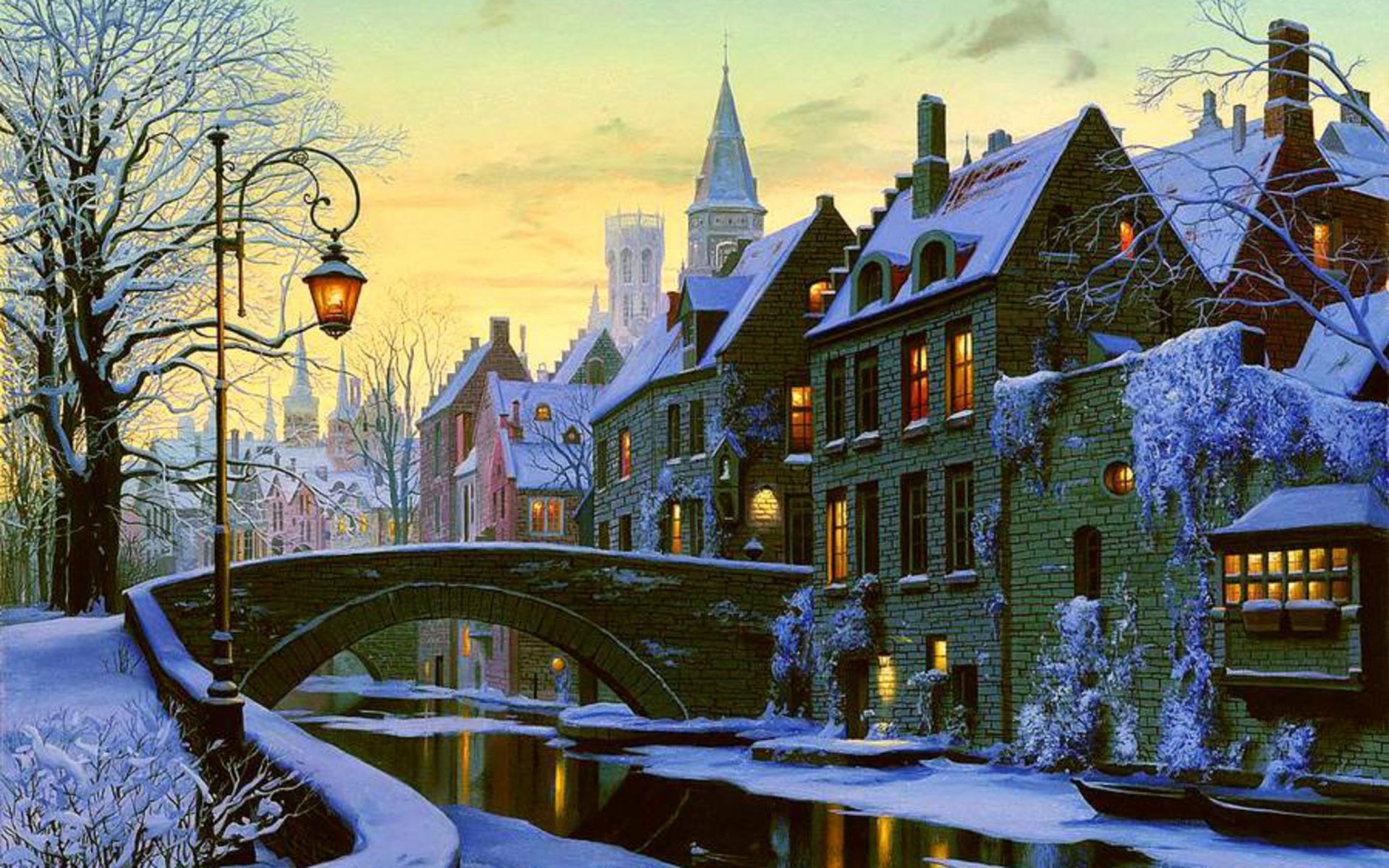 Artistic HD PC desktop wallpaper depicting a snowy cityscape with a stone bridge over a calm canal, old buildings, and warm street lamps glowing at sunset.
