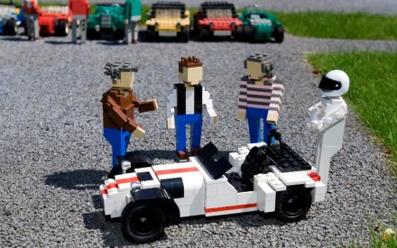 HD wallpaper featuring LEGO figures representing the Top Gear team next to a LEGO car on a gravel surface.