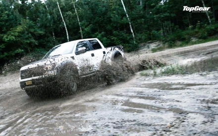 HD Top Gear desktop wallpaper featuring a pickup truck speedily driving through mud with splashes.
