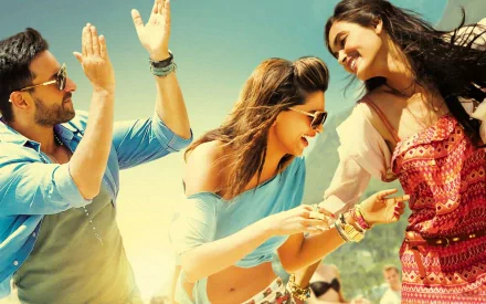 HD desktop wallpaper featuring a vibrant scene from the Bollywood movie Cocktail (2012) with three joyful characters enjoying a sunny moment together.