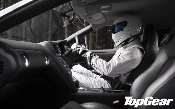 HD wallpaper featuring The Stig driving, with the Top Gear logo prominently displayed.
