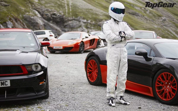 The Stig stands arms crossed in front of sports cars on a Top Gear HD desktop wallpaper.