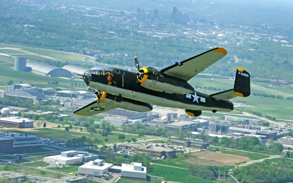 HD PC desktop wallpaper featuring a vintage military aircraft flying over a cityscape on a clear day.