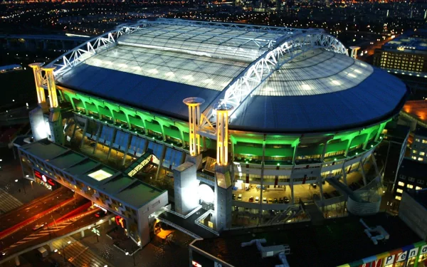Aerial night view of a brightly lit stadium with green accents, captured in HD as a PC desktop wallpaper showcasing a vibrant sports venue.