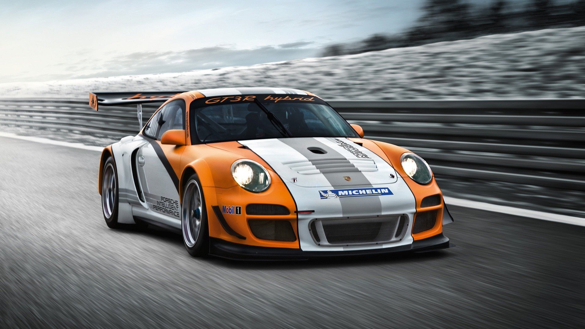 HD PC desktop wallpaper of an orange and white Porsche 911 GT3 speeding on a racetrack, prominent rear wing and detailed racing livery.