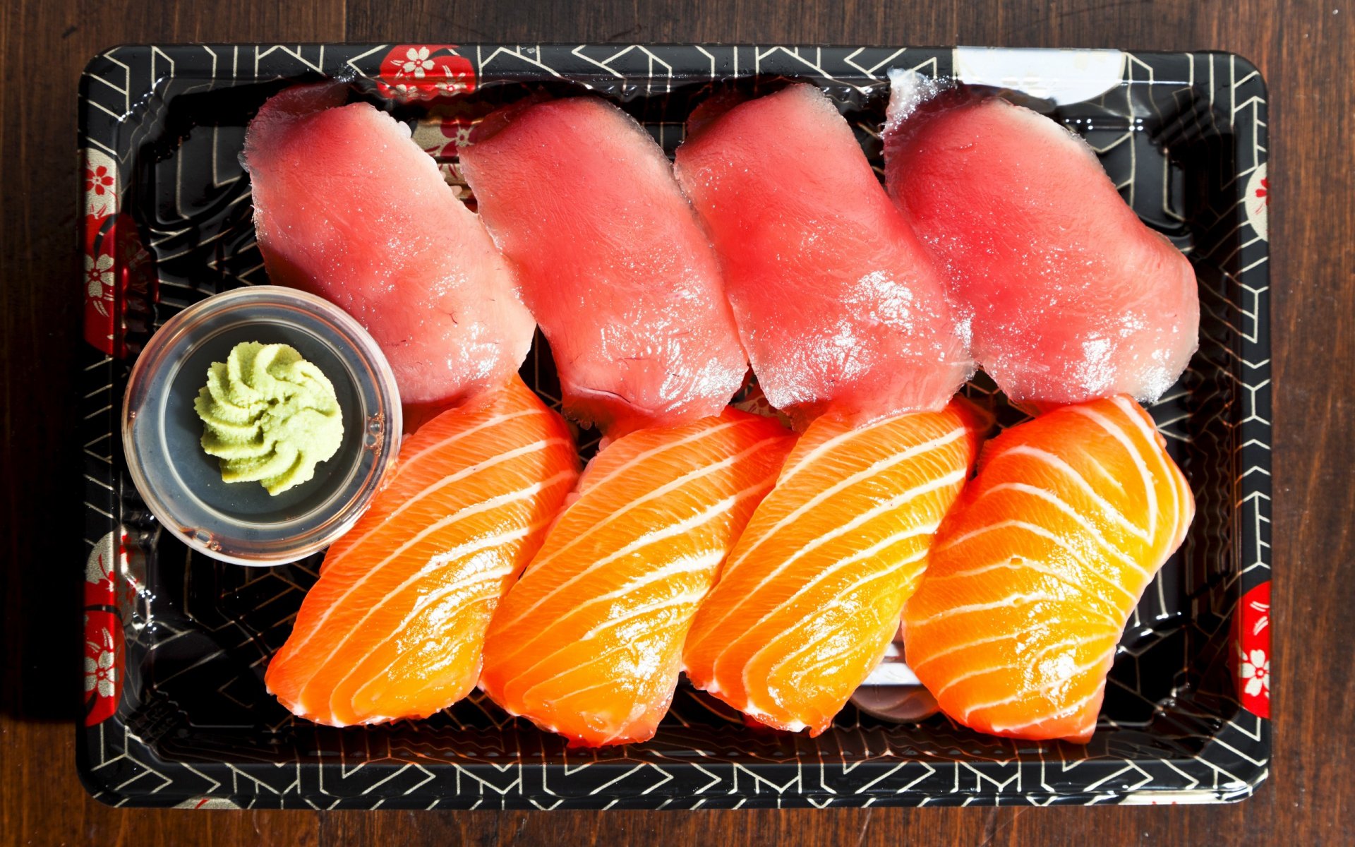 HD PC desktop wallpaper showcasing a tray of fresh sushi with vibrant slices of tuna and salmon, accompanied by a small portion of wasabi.