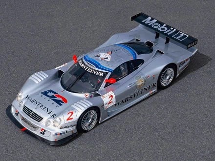 HD PC desktop wallpaper featuring a sleek silver Mercedes-Benz CLK GTR race car with Warsteiner and Mobil 1 branding, showcasing its aerodynamic design and detailed livery.
