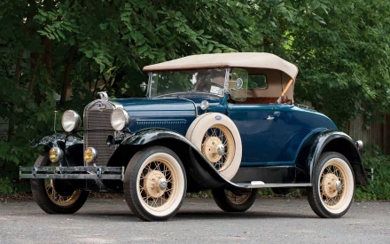 1929 Ford Model A Roadster in blue with beige soft top, showcased as an HD PC desktop wallpaper and background.