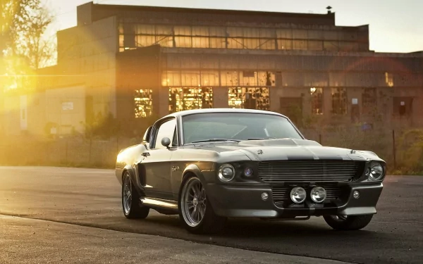 A Ford Mustang Shelby GT500 parked in front of an industrial building at sunset, showcased as an HD PC desktop wallpaper and background.