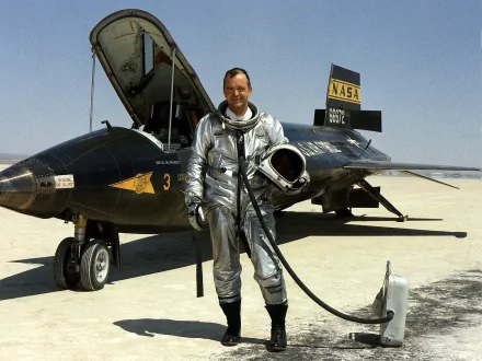 A North American X-15 aircraft on the ground with a pilot in a silver suit, showcasing military aviation history in a high-definition desktop wallpaper.
