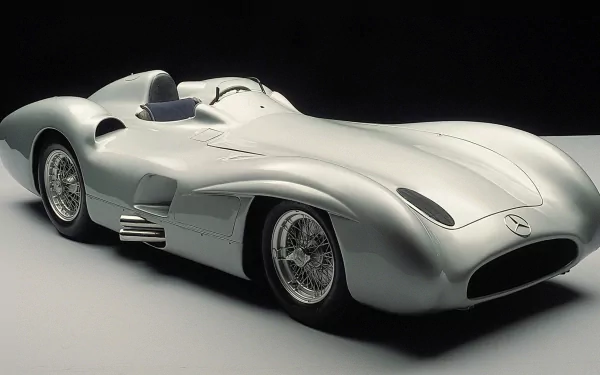 HD PC desktop wallpaper featuring a sleek silver Mercedes-Benz W196 classic racing car against a dark background.