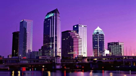 HD PC desktop wallpaper/background: Tampa, Florida skyline at dusk — man-made waterfront cityscape with illuminated skyscrapers reflecting on the river.