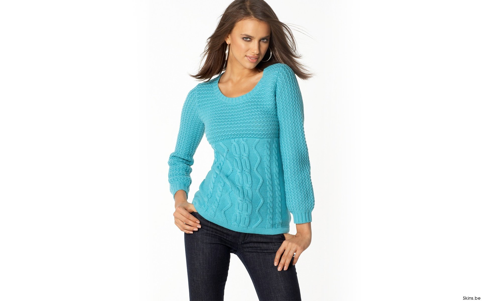 HD PC desktop wallpaper featuring celebrity Irina Shayk wearing a turquoise cable-knit sweater and dark jeans against a white background.