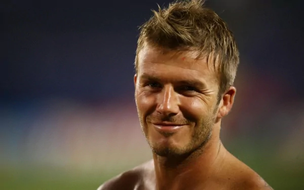 HD PC desktop wallpaper featuring a close-up of David Beckham smiling, captured in a sports setting with a blurred background.
