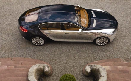HD wallpaper of a Bugatti Galibier from a top-down view, showcasing its shiny exterior on a cobblestone driveway.