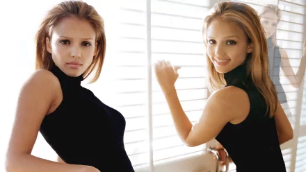 HD wallpaper featuring Jessica Alba, showcasing her in a stylish black top with soft lighting, creating an elegant and captivating look.