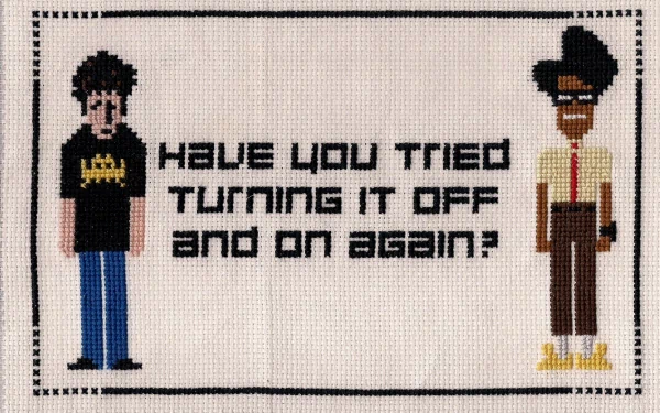 HD wallpaper featuring pixel-art representations of Maurice Moss and Roy Trenneman from The IT Crowd, with the text Have you tried turning it off and on again?