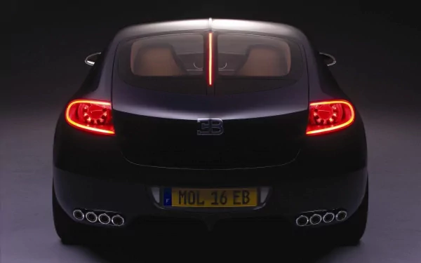 A sleek Bugatti Galibier is showcased in this HD desktop wallpaper, featuring its striking rear design and lights against a dark background.