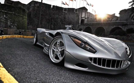 HD PC desktop wallpaper and background of a silver Vermot Veritas RS III sports vehicle, shown low-angle on asphalt beside stone walls with the sun setting behind it.