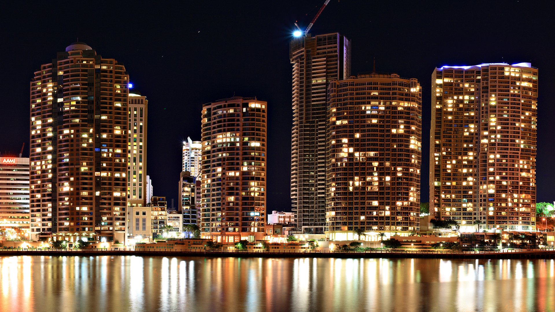 Brisbane, Australia skyline at night — illuminated high-rise buildings reflecting on the river; HD man-made cityscape desktop wallpaper.