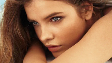 Close-up of celebrity Barbara Palvin with striking blue eyes, looking thoughtfully into the distance. This HD image serves as a captivating desktop wallpaper background.