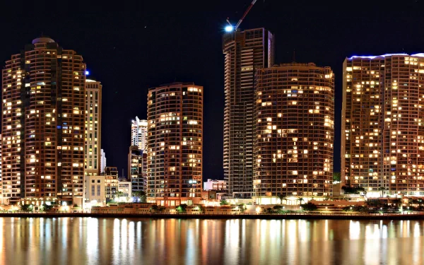Brisbane, Australia skyline at night — illuminated high-rise buildings reflecting on the river; HD man-made cityscape desktop wallpaper.