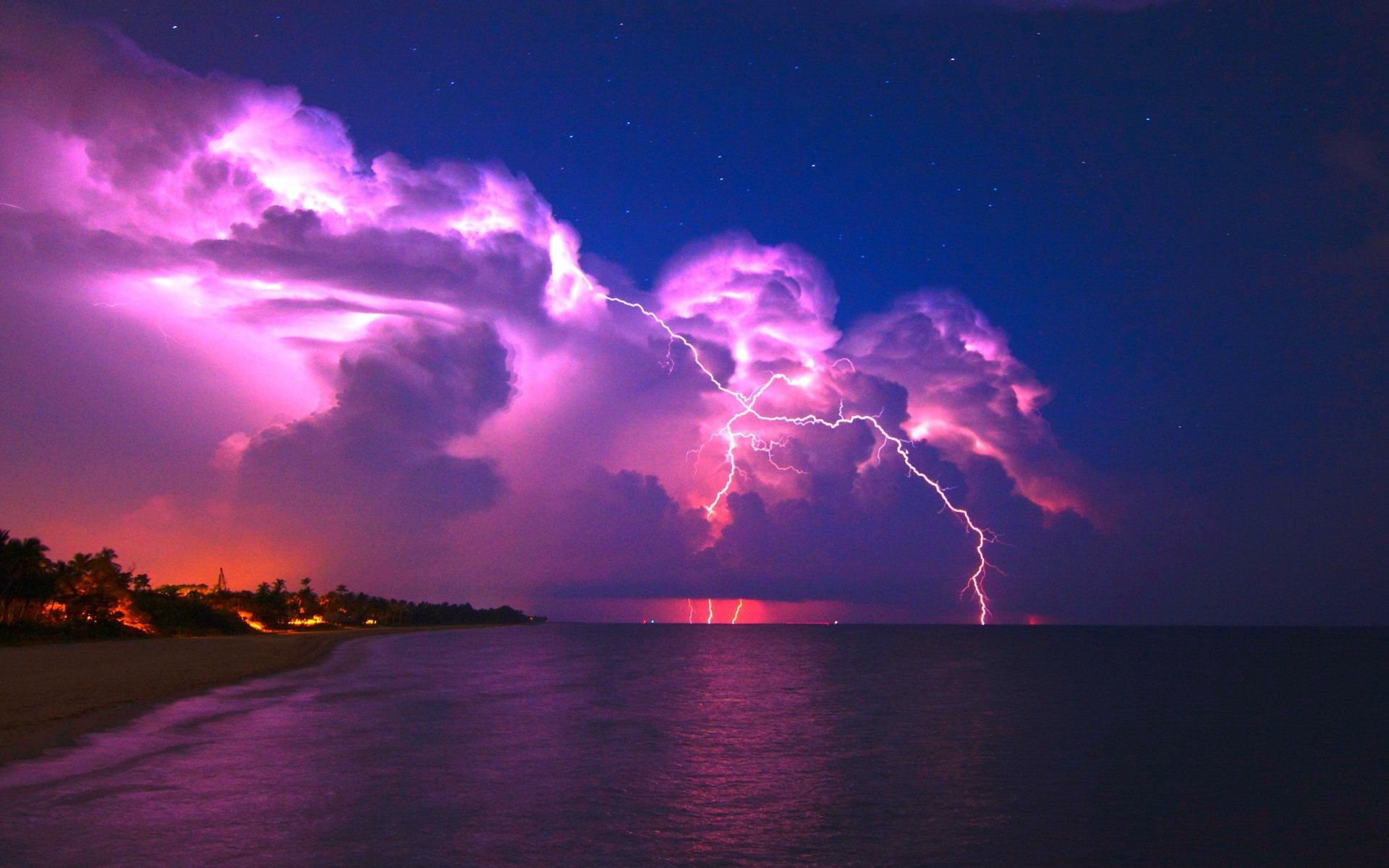 HD photography of lightning striking over a calm ocean at night, with vibrant purple and pink hues illuminating the clouds, creating a dramatic desktop wallpaper background.