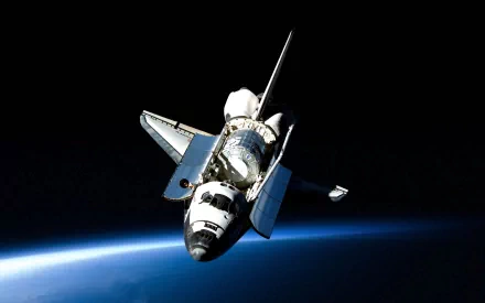 A stunning HD wallpaper of Space Shuttle Discovery soaring above Earth, showcasing its sleek design against the backdrop of space and the planet's blue horizon.