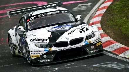 HD PC desktop wallpaper featuring a BMW Z4 GT3 racing on a track, showcasing its sleek design and performance as a high-speed vehicle in motorsport.