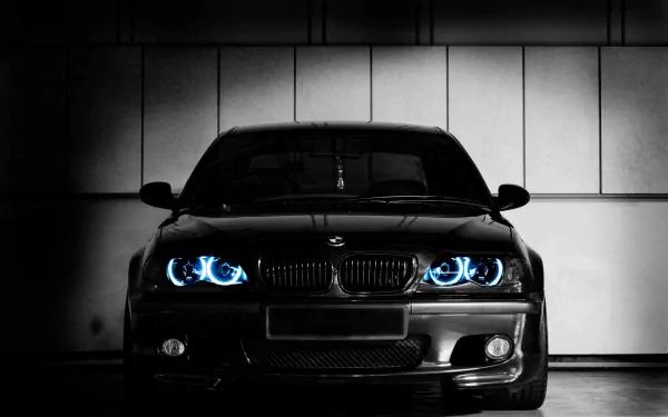 HD PC desktop wallpaper featuring a black BMW M3 with glowing blue headlights against a dark, industrial background.