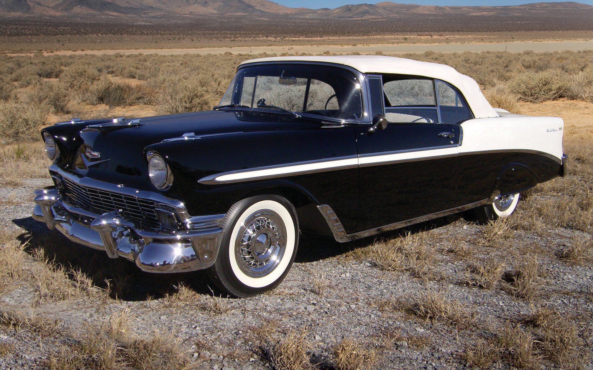 1956 Chevrolet Bel Air parked on dry grassland, captured in high definition for a classic vehicle PC desktop wallpaper.