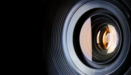 A close-up view of a camera lens, showcasing intricate details and reflections. This 4K Ultra HD image serves as an engaging desktop wallpaper and background.